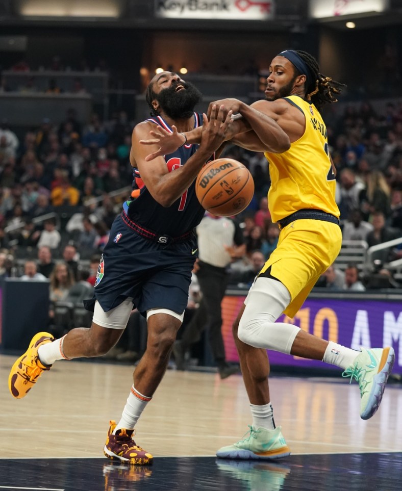 Apr 5, 2022; Indianapolis, Indiana, USA;  Philadelphia 76ers guard James Harden (1) is fouled by Indiana Pacers forward Isaiah Jackson (23) in the first half at Gainbridge Fieldhouse. Mandatory Credit: Robert Goddin-USA TODAY Sports