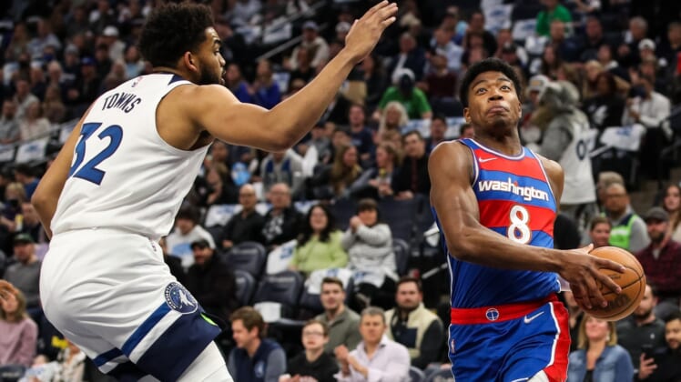 Apr 5, 2022; Minneapolis, Minnesota, USA; Washington Wizards forward Rui Hachimura (8) drives to the basket while Minnesota Timberwolves center Karl-Anthony Towns (32) defends in the first quarter at Target Center. Mandatory Credit: David Berding-USA TODAY Sports