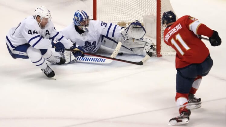 Apr 5, 2022; Sunrise, Florida, USA; Florida Panthers left wing Jonathan Huberdeau (11) scores the game winning goal past Toronto Maple Leafs goaltender Jack Campbell (36) during the overtime period at FLA Live Arena. Mandatory Credit: Jasen Vinlove-USA TODAY Sports