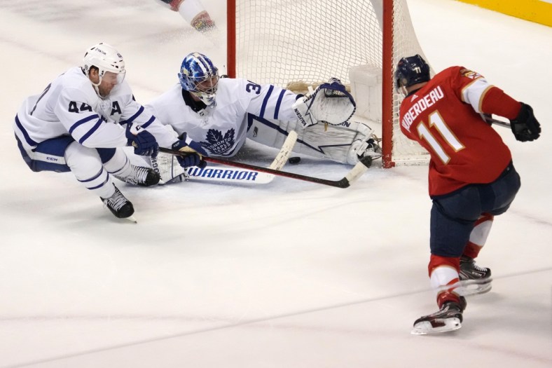 Apr 5, 2022; Sunrise, Florida, USA; Florida Panthers left wing Jonathan Huberdeau (11) scores the game winning goal past Toronto Maple Leafs goaltender Jack Campbell (36) during the overtime period at FLA Live Arena. Mandatory Credit: Jasen Vinlove-USA TODAY Sports