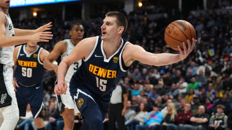 Apr 5, 2022; Denver, Colorado, USA; Denver Nuggets center Nikola Jokic (15) grabs a loose ball in the second quarter against the San Antonio Spurs at Ball Arena. Mandatory Credit: Ron Chenoy-USA TODAY Sports