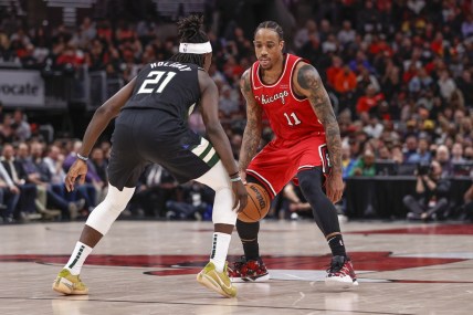 Apr 5, 2022; Chicago, Illinois, USA; Chicago Bulls forward DeMar DeRozan (11) handles the ball defended by Milwaukee Bucks guard Jrue Holiday (21) during the second half at United Center. Mandatory Credit: Kamil Krzaczynski-USA TODAY Sports