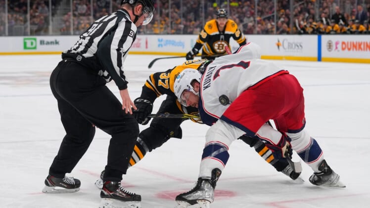 Apr 2, 2022; Boston, Massachusetts, USA; Boston Bruins center Patrice Bergeron (37) and Columbus Blue Jackets center Sean Kuraly (7) face off during the third period at TD Garden. Mandatory Credit: Gregory Fisher-USA TODAY Sports