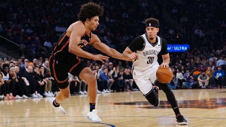 Apr 6, 2022; New York, New York, USA; Brooklyn Nets shooting guard Seth Curry (30)m dribbles the ball against New York Knicks power forward Jericho Sims (45)  during the first half at Madison Square Garden. Mandatory Credit: Gregory Fisher-USA TODAY Sports