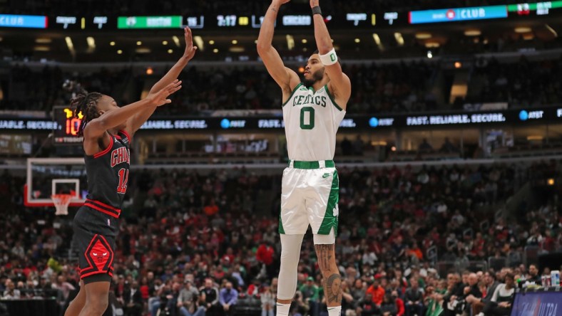 Apr 6, 2022; Chicago, Illinois, USA;Boston Celtics forward Jayson Tatum (0) shoots over Chicago Bulls guard Ayo Dosunmu (12)  during the first quarter at the United Center. Mandatory Credit: Dennis Wierzbicki-USA TODAY Sports