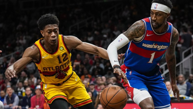 Apr 6, 2022; Atlanta, Georgia, USA; Washington Wizards guard Kentavious Caldwell-Pope (1) tries to make a play against Atlanta Hawks forward De'Andre Hunter (12) during the first half at State Farm Arena. Mandatory Credit: Dale Zanine-USA TODAY Sports