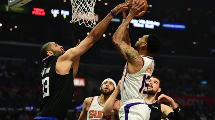 Apr 6, 2022; Los Angeles, California, USA;  Phoenix Suns guard Cameron Payne (15) shoots against Los Angeles Clippers forward Nicolas Batum (33) during the first half at Crypto.com Arena. Mandatory Credit: Gary A. Vasquez-USA TODAY Sports