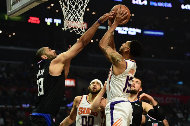 Apr 6, 2022; Los Angeles, California, USA;  Phoenix Suns guard Cameron Payne (15) shoots against Los Angeles Clippers forward Nicolas Batum (33) during the first half at Crypto.com Arena. Mandatory Credit: Gary A. Vasquez-USA TODAY Sports