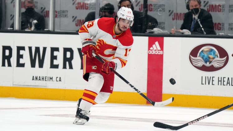 Apr 6, 2022; Anaheim, California, USA; Calgary Flames left wing Johnny Gaudreau (13) shoots the puck against the Anaheim Ducks in the first period at Honda Center. Mandatory Credit: Kirby Lee-USA TODAY Sports