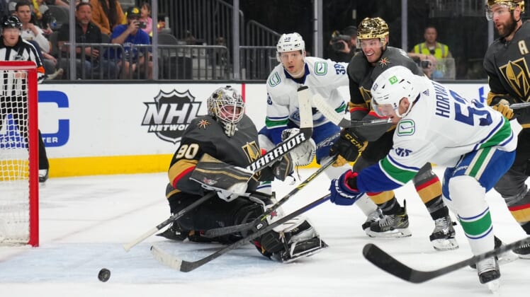 Apr 6, 2022; Las Vegas, Nevada, USA; Vancouver Canucks center Bo Horvat (53) scores a goal against Vegas Golden Knights goaltender Robin Lehner (90) during the first period at T-Mobile Arena. Mandatory Credit: Stephen R. Sylvanie-USA TODAY Sports
