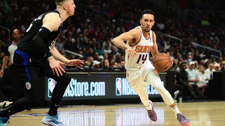 Apr 6, 2022; Los Angeles, California, USA; Phoenix Suns guard Landry Shamet (14) moves to the basket against Los Angeles Clippers center Isaiah Hartenstein (55)  during the first half at Crypto.com Arena. Mandatory Credit: Gary A. Vasquez-USA TODAY Sports