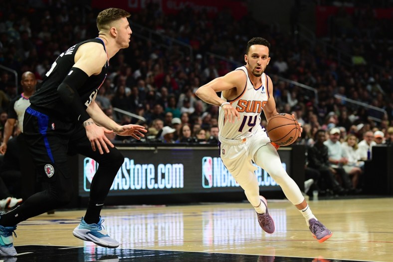 Apr 6, 2022; Los Angeles, California, USA; Phoenix Suns guard Landry Shamet (14) moves to the basket against Los Angeles Clippers center Isaiah Hartenstein (55)  during the first half at Crypto.com Arena. Mandatory Credit: Gary A. Vasquez-USA TODAY Sports