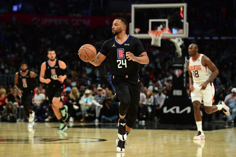 Apr 6, 2022; Los Angeles, California, USA;Los Angeles Clippers forward Norman Powell (24) moves the ball up court against the Phoenix Suns during the second half at Crypto.com Arena. Mandatory Credit: Gary A. Vasquez-USA TODAY Sports