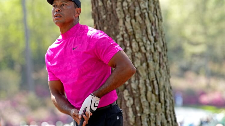 Apr 7, 2022; Augusta, Georgia, USA; Tiger Woods plays from the rough on the 14th hole during the first round of The Masters golf tournament. Mandatory Credit: Rob Schumacher-USA TODAY Sports