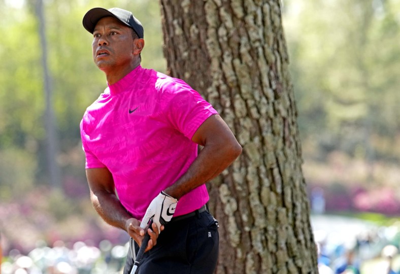 Apr 7, 2022; Augusta, Georgia, USA; Tiger Woods plays from the rough on the 14th hole during the first round of The Masters golf tournament. Mandatory Credit: Rob Schumacher-USA TODAY Sports