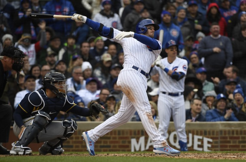 Apr 7, 2022; Chicago, Illinois, USA;  Chicago Cubs center fielder Ian Happ (8) hits a two run double against the Milwaukee Brewers during the seventh inning at Wrigley Field. Mandatory Credit: Matt Marton-USA TODAY Sports