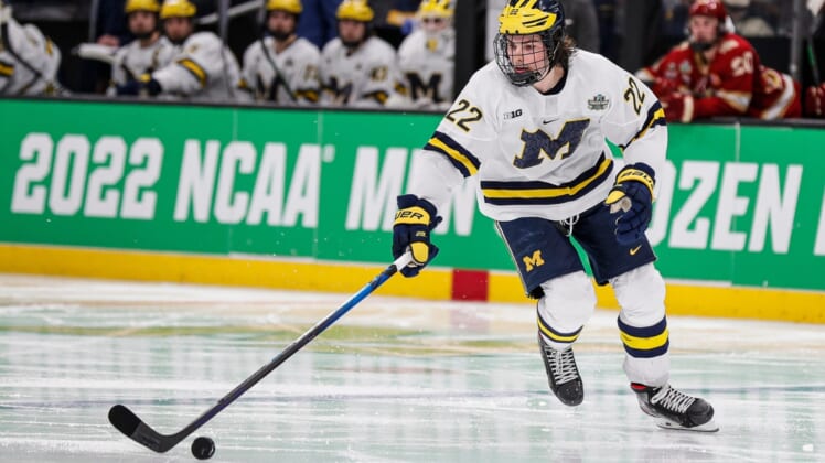 Michigan defenseman Owen Power looks to pass against Denver during the second period of the Frozen Four semifinal at the TD Garden in Boston, Mass. on Thursday, April 7, 2022.