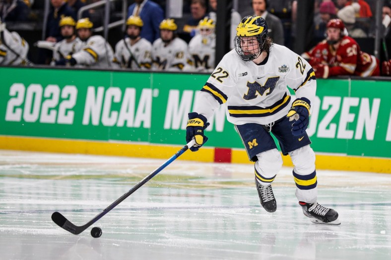 Michigan defenseman Owen Power looks to pass against Denver during the second period of the Frozen Four semifinal at the TD Garden in Boston, Mass. on Thursday, April 7, 2022.