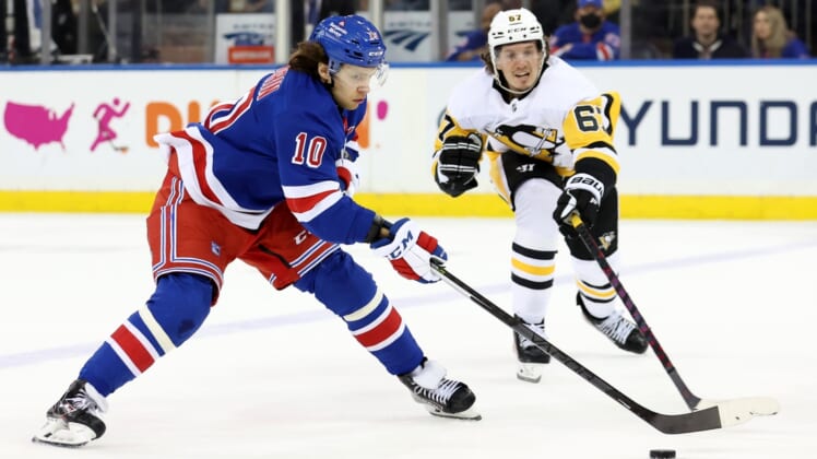 Apr 7, 2022; New York, New York, USA; New York Rangers left wing Artemi Panarin (10) controls the puck against Pittsburgh Penguins right wing Rickard Rakell (67) during the first period at Madison Square Garden. Mandatory Credit: Brad Penner-USA TODAY Sports