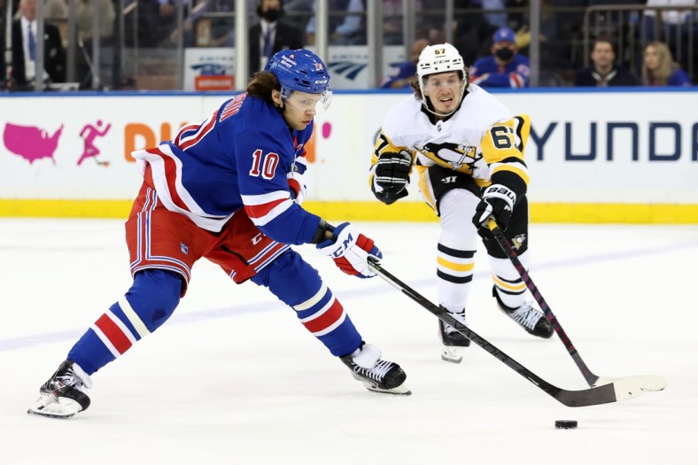 Apr 7, 2022; New York, New York, USA; New York Rangers left wing Artemi Panarin (10) controls the puck against Pittsburgh Penguins right wing Rickard Rakell (67) during the first period at Madison Square Garden. Mandatory Credit: Brad Penner-USA TODAY Sports