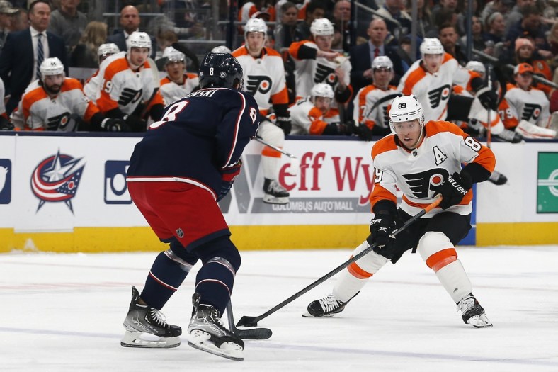 Apr 7, 2022; Columbus, Ohio, USA; Philadelphia Flyers right wing Cam Atkinson (89) looks to pass as Columbus Blue Jackets defenseman Zach Werenski (8) defends during the first period at Nationwide Arena. Mandatory Credit: Russell LaBounty-USA TODAY Sports