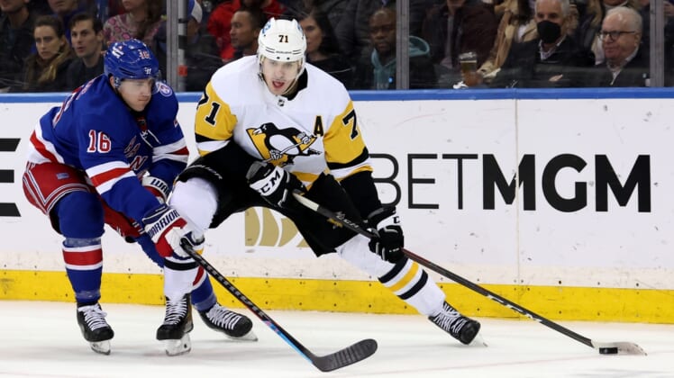 Apr 7, 2022; New York, New York, USA; Pittsburgh Penguins center Evgeni Malkin (71) controls the puck against New York Rangers center Ryan Strome (16) during the second period at Madison Square Garden. Mandatory Credit: Brad Penner-USA TODAY Sports
