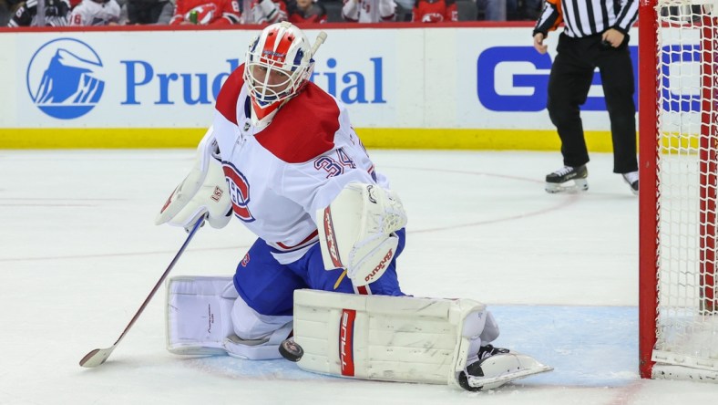 Apr 7, 2022; Newark, New Jersey, USA; Montreal Canadiens goaltender Jake Allen (34) makes a save against the New Jersey Devils during the second period at Prudential Center. Mandatory Credit: Ed Mulholland-USA TODAY Sports