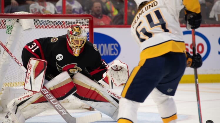 Apr 7, 2022; Ottawa, Ontario, CAN; Ottawa Senators goalie Anton Forsberg (31) defends the goal in front of Nashville Predators center Mikael Granlund (64) in the first period at the Canadian Tire Centre. Mandatory Credit: Marc DesRosiers-USA TODAY Sports