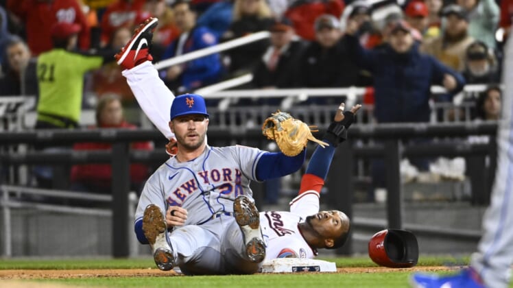 Apr 7, 2022; Washington, District of Columbia, USA; New York Mets first baseman Pete Alonso (20) is unable to apply a tag to Washington Nationals shortstop Alcides Escobar (rear) during the third inning at Nationals Park. Mandatory Credit: Brad Mills-USA TODAY Sports