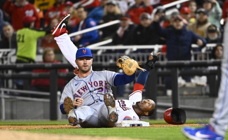 Apr 7, 2022; Washington, District of Columbia, USA; New York Mets first baseman Pete Alonso (20) is unable to apply a tag to Washington Nationals shortstop Alcides Escobar (rear) during the third inning at Nationals Park. Mandatory Credit: Brad Mills-USA TODAY Sports