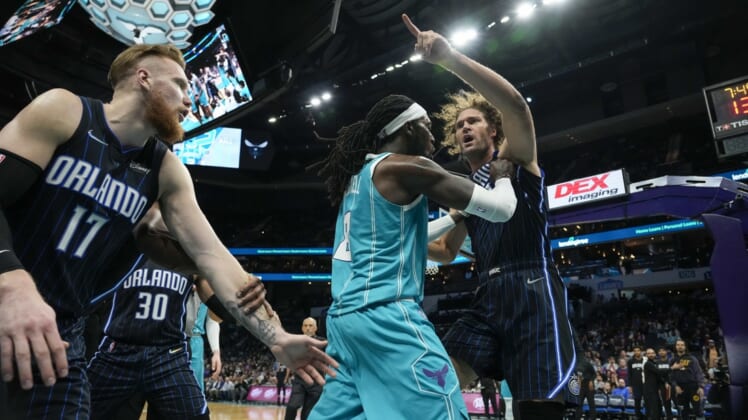 Apr 7, 2022; Charlotte, North Carolina, USA; Charlotte Hornets center Montrezl Harrell (8) tries to clear Orlando Magic center Robin Lopez (right) from an altercation that would later see both players ejected, as well as Magic forward Admiral Schofield (not pictured) during the second half at Spectrum Center. Mandatory Credit: Jim Dedmon-USA TODAY Sports