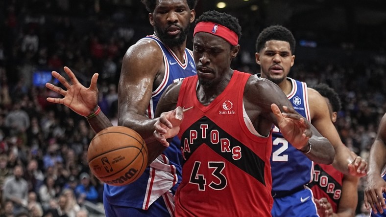 Apr 7, 2022; Toronto, Ontario, CAN; Philadelphia 76ers center Joel Embiid (21) knocks the ball away from Toronto Raptors forward Pascal Siakam (43) during the second half at Scotiabank Arena. Mandatory Credit: John E. Sokolowski-USA TODAY Sports