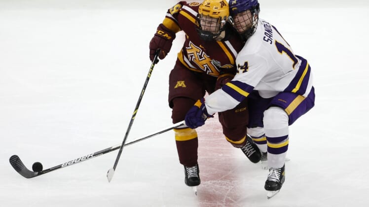 Apr 7, 2022; Boston, MA, USA; Minnesota forward Ben Meyers (39) collides with Minnesota State forward Ryan Sandelin (14) going for the puck during the second period of the 2022 Frozen Four college ice hockey national semifinals at TD Garden. Mandatory Credit: Winslow Townson-USA TODAY Sports