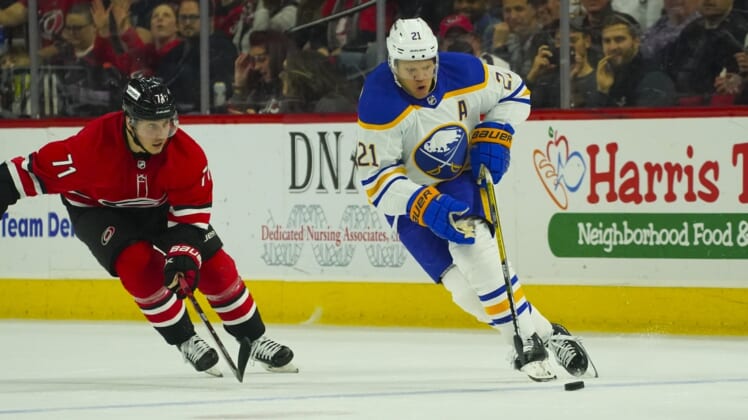 Apr 7, 2022; Raleigh, North Carolina, USA;  Buffalo Sabres right wing Kyle Okposo (21) skates with the puck against the Carolina Hurricanes during the third period at PNC Arena. Mandatory Credit: James Guillory-USA TODAY Sports