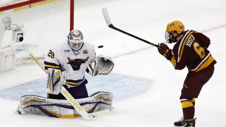 Apr 7, 2022; Boston, MA, USA; Minnesota State goaltender Dryden McKay (29) makes a save as Minnesota defenseman Mike Koster (6) looks for the rebound during the third period of the 2022 Frozen Four college ice hockey national semifinals at TD Garden. Mandatory Credit: Winslow Townson-USA TODAY Sports