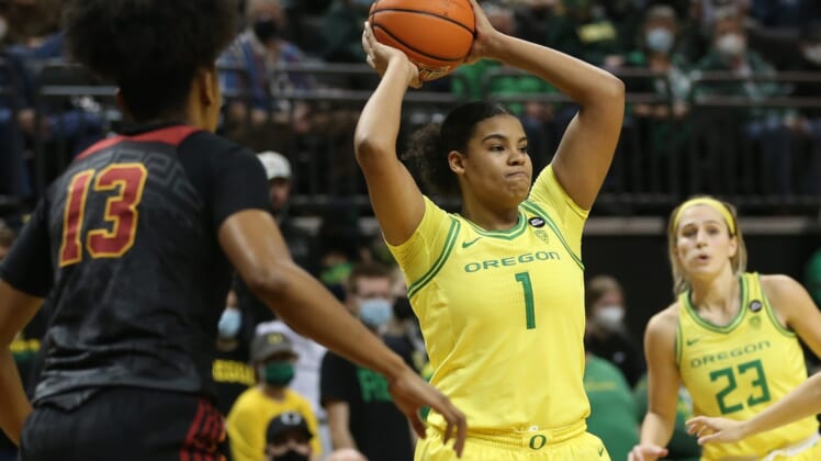 Oregon's Nyara Sabally, center, passes the ball out of the key against USC during the second half Jan. 30, 2022.Syndication The Register Guard