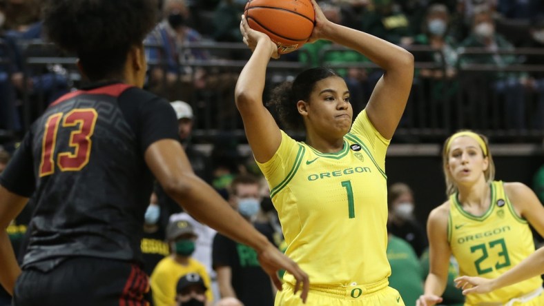 Oregon's Nyara Sabally, center, passes the ball out of the key against USC during the second half Jan. 30, 2022.

Syndication The Register Guard