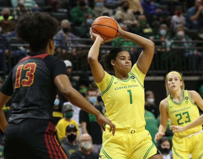 Oregon's Nyara Sabally, center, passes the ball out of the key against USC during the second half Jan. 30, 2022.

Syndication The Register Guard