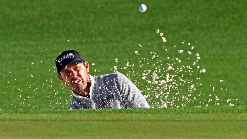 Apr 8, 2022; Augusta, Georgia, USA; Charl Schwartzel plays a shot from a bunker on the second hole during the second round of The Masters golf tournament. Mandatory Credit: Kyle Terada-USA TODAY Sports