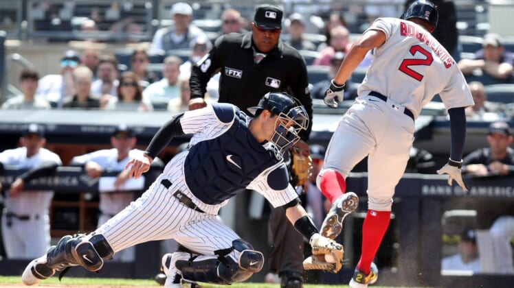 Yankee catcher Kyle Higashioka is a little late on the tag of Red Sox Xander Bogaert as he scores on an rbi single by teammate J.D. Martinez during opening day action at Yankee Stadium April 8, 2022.Yankees Opening Day