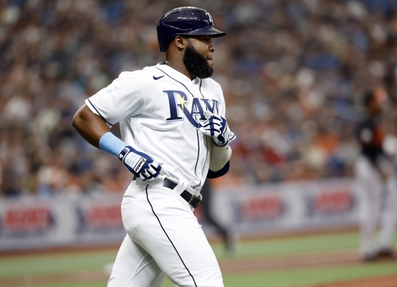 Apr 8, 2022; St. Petersburg, Florida, USA; Tampa Bay Rays right fielder Manuel Margot (13) singles in the second inning against the Baltimore Orioles  at Tropicana Field. Mandatory Credit: Kim Klement-USA TODAY Sports