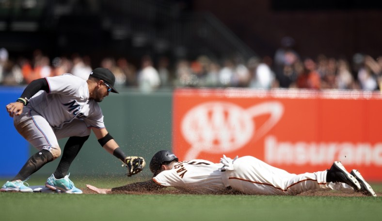 Apr 8, 2022; San Francisco, California, USA; Miami Marlins shortstop Miguel Rojas (11) tags out San Francisco Giants right fielder Mike Yastrzemski (5) as he attempts to steal second base during the fifth inning at Oracle Park. Mandatory Credit: D. Ross Cameron-USA TODAY Sports