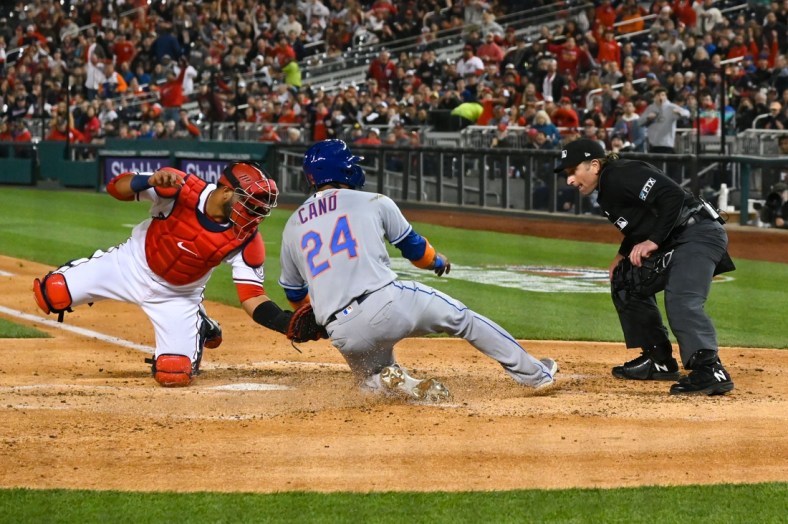 Apr 8, 2022; Washington, District of Columbia, USA;  Washington Nationals catcher Keibert Ruiz (20) tags New York Mets second baseman Robinson Cano (24) out at the plate to end the fourth inning at Nationals Park. Mandatory Credit: Tommy Gilligan-USA TODAY Sports