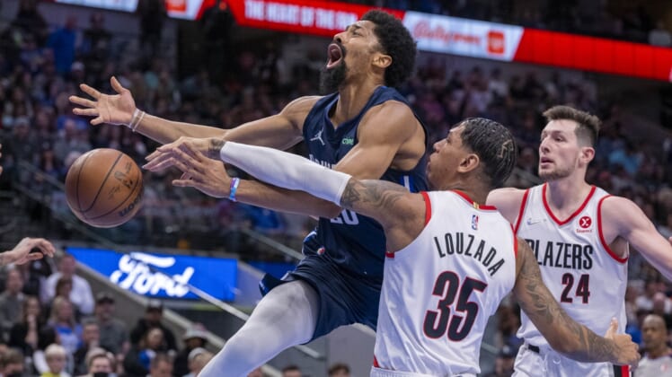 Apr 8, 2022; Dallas, Texas, USA; Dallas Mavericks guard Spencer Dinwiddie (26) is fouled by Portland Trail Blazers forward Didi Louzada (35) during the second quarter at the American Airlines Center. Mandatory Credit: Jerome Miron-USA TODAY Sports