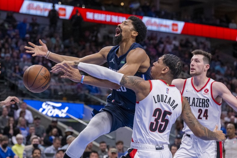 Apr 8, 2022; Dallas, Texas, USA; Dallas Mavericks guard Spencer Dinwiddie (26) is fouled by Portland Trail Blazers forward Didi Louzada (35) during the second quarter at the American Airlines Center. Mandatory Credit: Jerome Miron-USA TODAY Sports