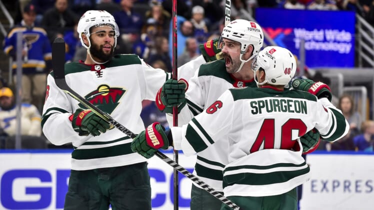 Apr 8, 2022; St. Louis, Missouri, USA;  Minnesota Wild defenseman Jacob Middleton (5) celebrates with defenseman Jared Spurgeon (46) and left wing Jordan Greenway (18) after scoring against the St. Louis Blues during the third period at Enterprise Center. Mandatory Credit: Jeff Curry-USA TODAY Sports