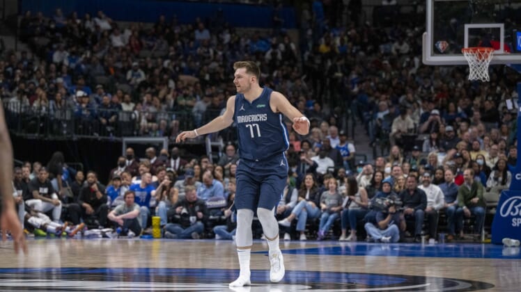 Apr 8, 2022; Dallas, Texas, USA; Dallas Mavericks guard Luka Doncic (77) runs back up the court with only one shoe on during the second half against the Portland Trail Blazers at the American Airlines Center. Mandatory Credit: Jerome Miron-USA TODAY Sports