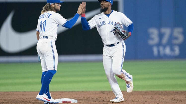 Apr 8, 2022; Toronto, Ontario, CAN; Toronto Blue Jays right fielder Teoscar Hernandez (37) and shortstop Bo Bichette (11) celebrate the win at the end of the ninth inning against the Texas Rangers at Rogers Centre . Mandatory Credit: Nick Turchiaro-USA TODAY Sports