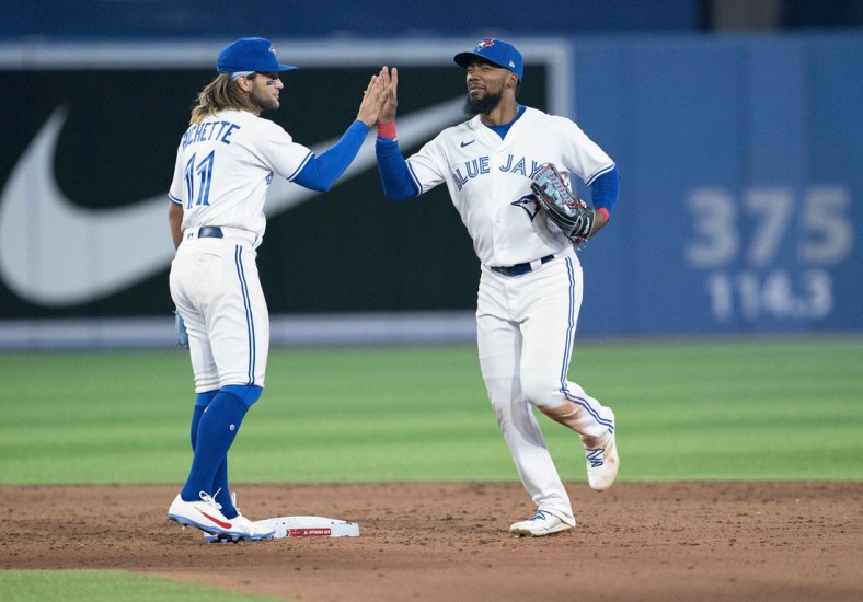 Apr 8, 2022; Toronto, Ontario, CAN; Toronto Blue Jays right fielder Teoscar Hernandez (37) and shortstop Bo Bichette (11) celebrate the win at the end of the ninth inning against the Texas Rangers at Rogers Centre . Mandatory Credit: Nick Turchiaro-USA TODAY Sports
