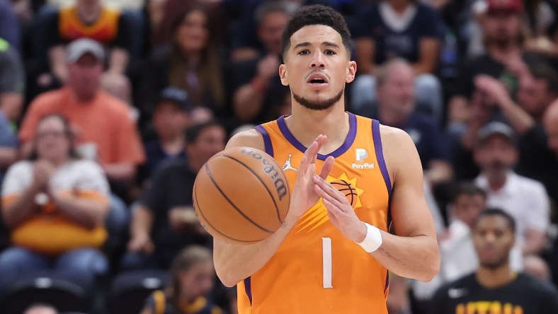 Apr 8, 2022; Salt Lake City, Utah, USA; Phoenix Suns guard Devin Booker (1) calls out a play while brings the ball up the court in the third quarter against the Utah Jazz at Vivint Arena. Mandatory Credit: Rob Gray-USA TODAY Sports